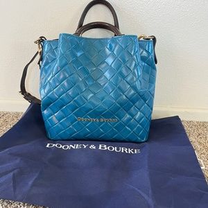 Dooney & Bourke shoulder bag in a vibrant turquoise hue.